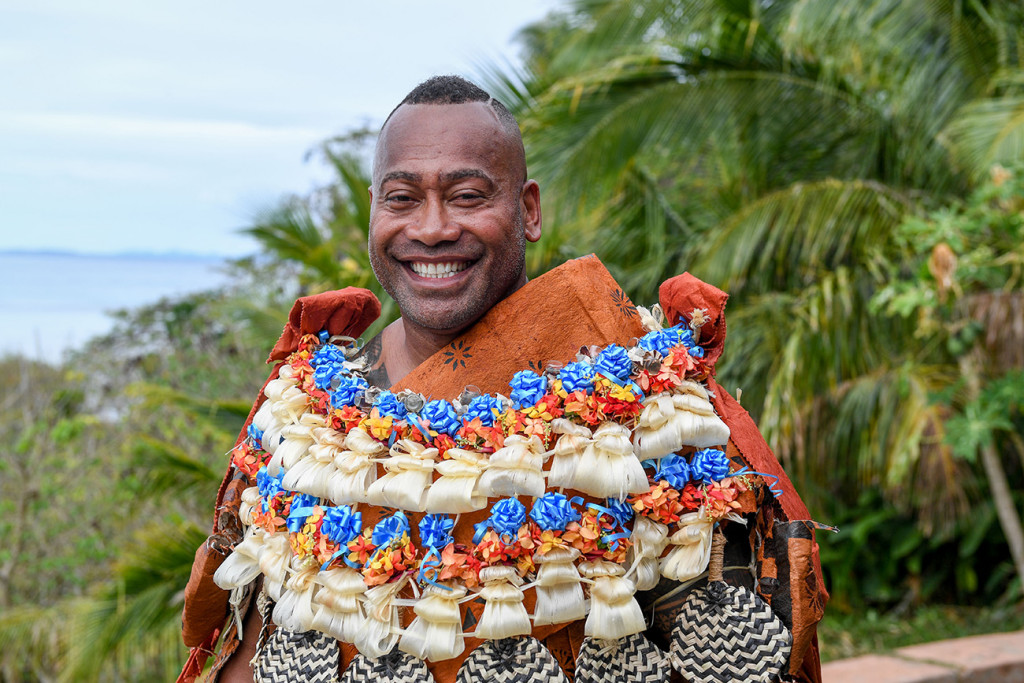 A super happy groom poses in traditional Fiji masi ready for his wedding