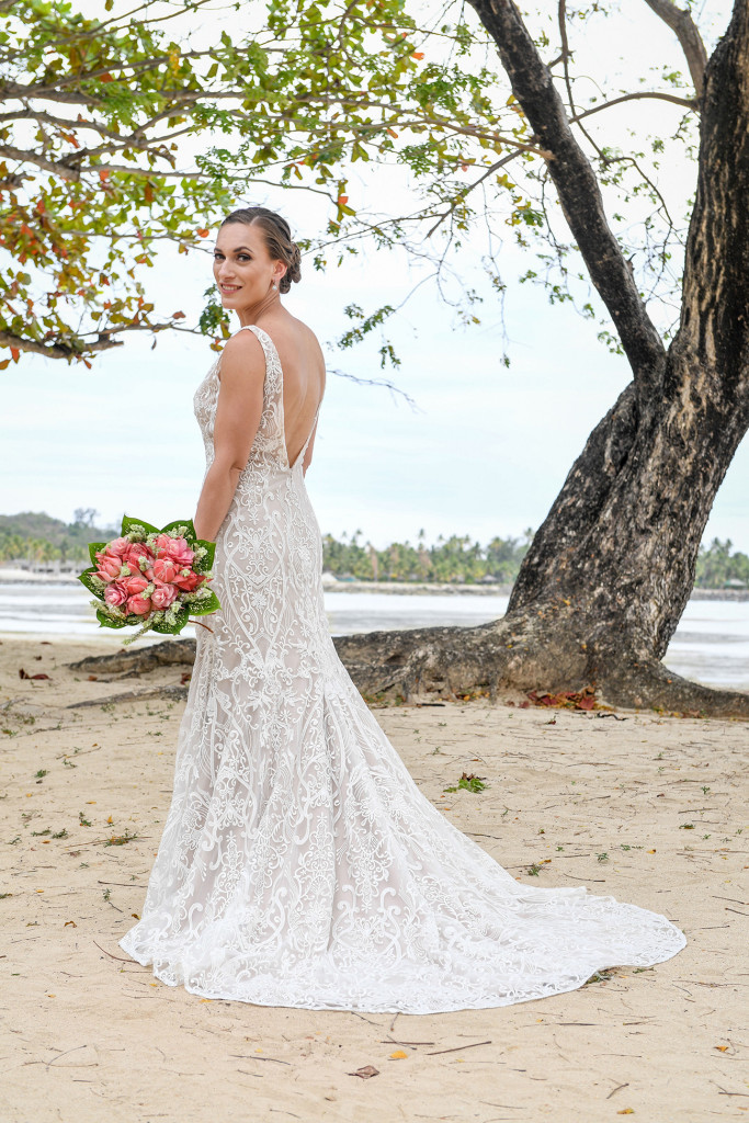 The stunning bride poses on the shores of the beach at Musket Cove
