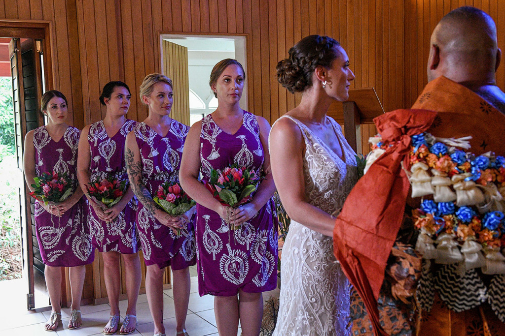 The bridesmaids lineup watch as the bride and groom exchange vows