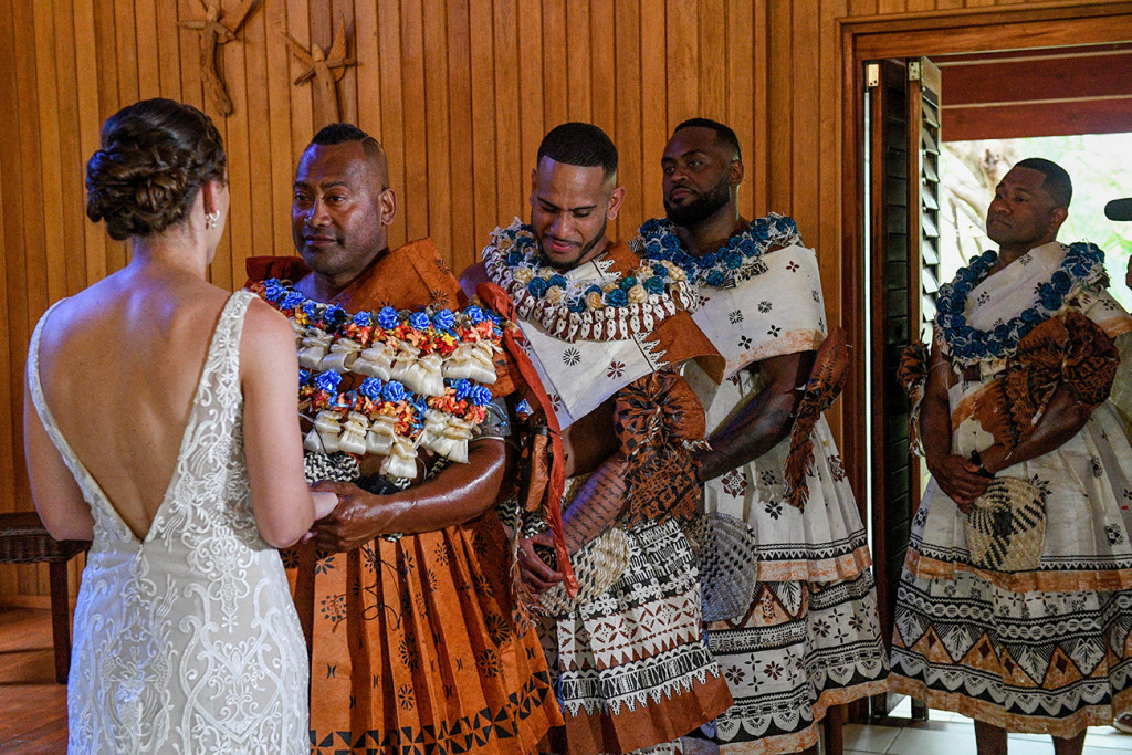 Groomsmen watch as the bride says her vows