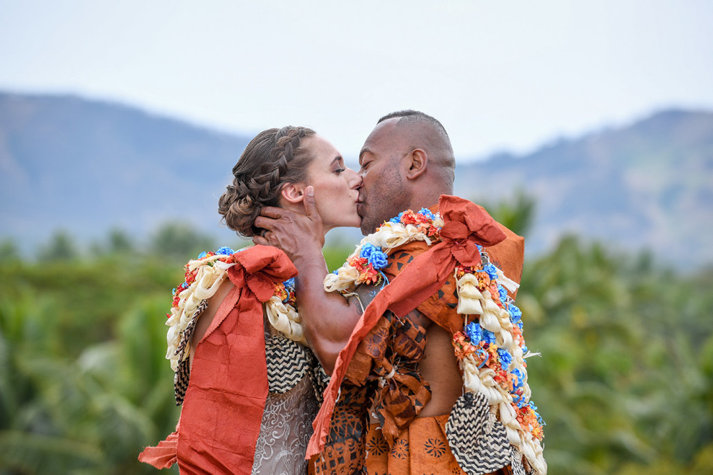 The Fiji groom passionately kisses his bride at Musket Cove