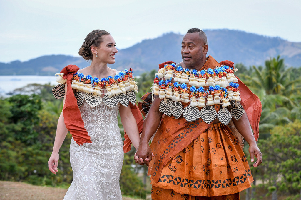 Newly Married Fiji couple walk hand in hand against the breathtaking Fiji landscape