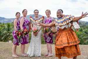 The groom photobombs the bridesmaids with a cheeky smile