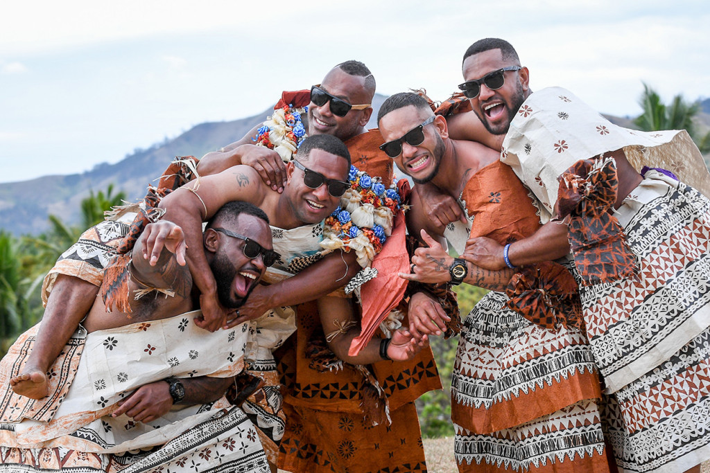 The Fiji groom and his groomsmen jump into a gigantic group hug