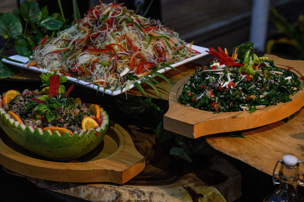 Colourful salads served in natural watermelon and wooden salad bowls