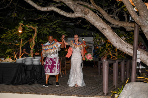 The newly married Fiji bride and groom arrive at the reception venue holding hands