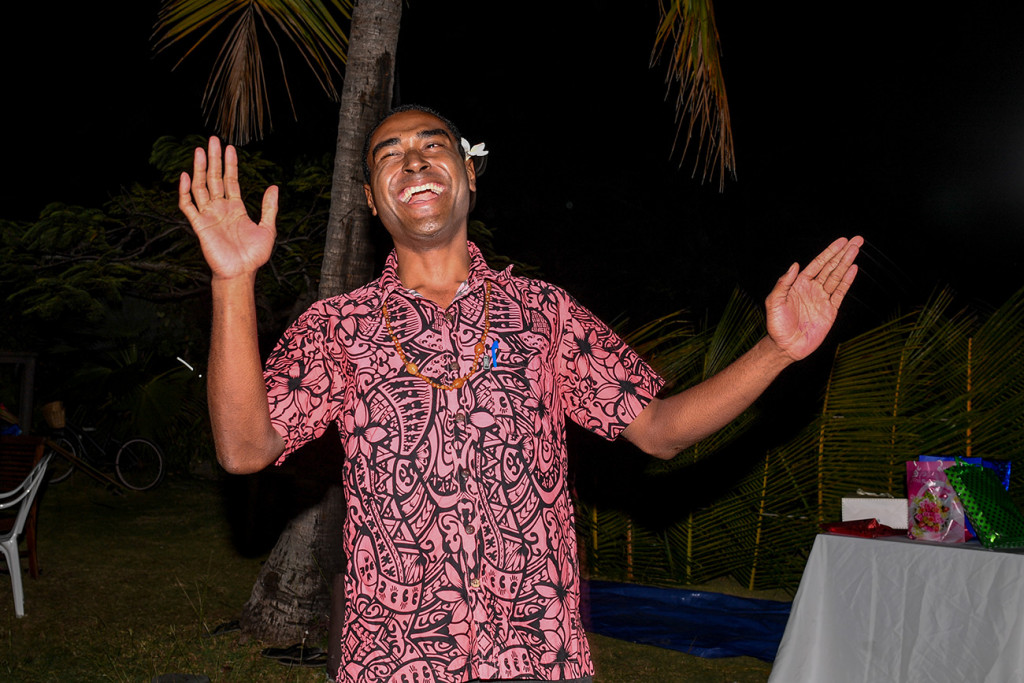A Fiji family member dances with joy
