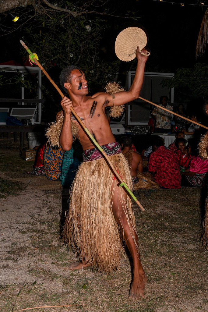 A Fiji warrior dancing with his fan and staff