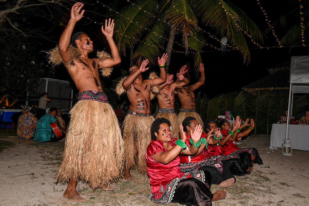 Traditional Fiji performers sing and dance on the beach at Musket Cove