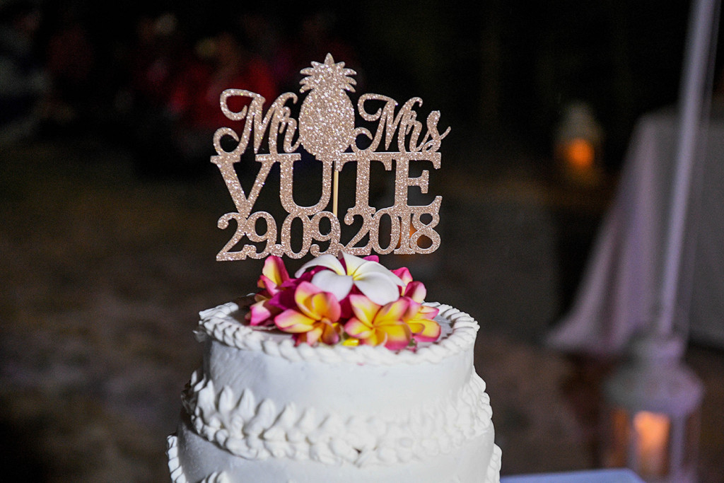 Brilliant white cake topped with colourful frangipani flowers with Mr and Mrs Vute topper