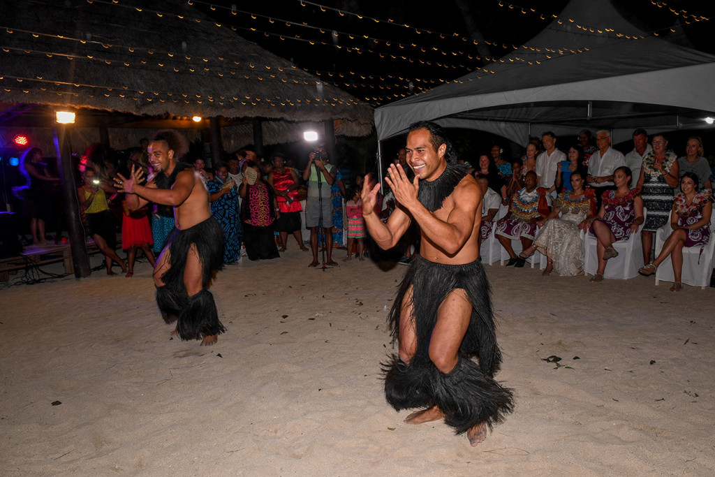 Male performers dressed in black sisal entertain the wedding party