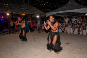 Male performers dressed in black sisal entertain the wedding party