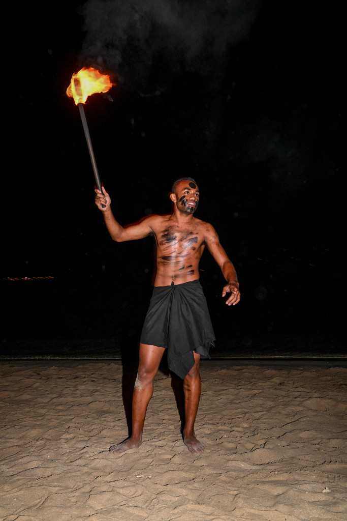 A Fiji performer starts up the fire display
