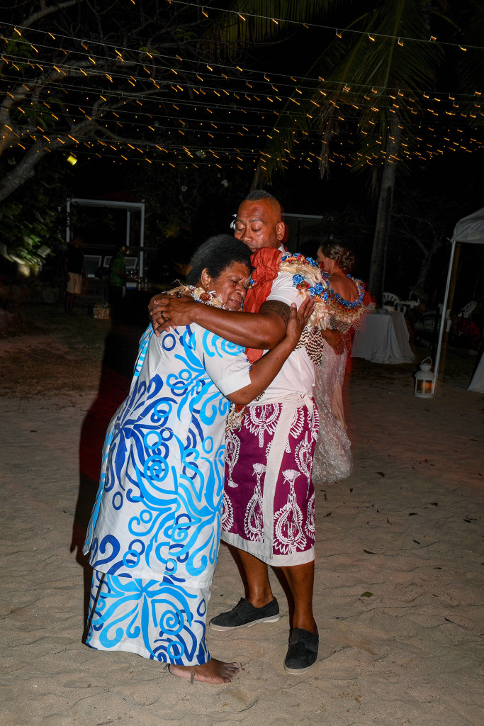 The groom hugs his mother as he dances with her on the beach at Musket Cove Fiji