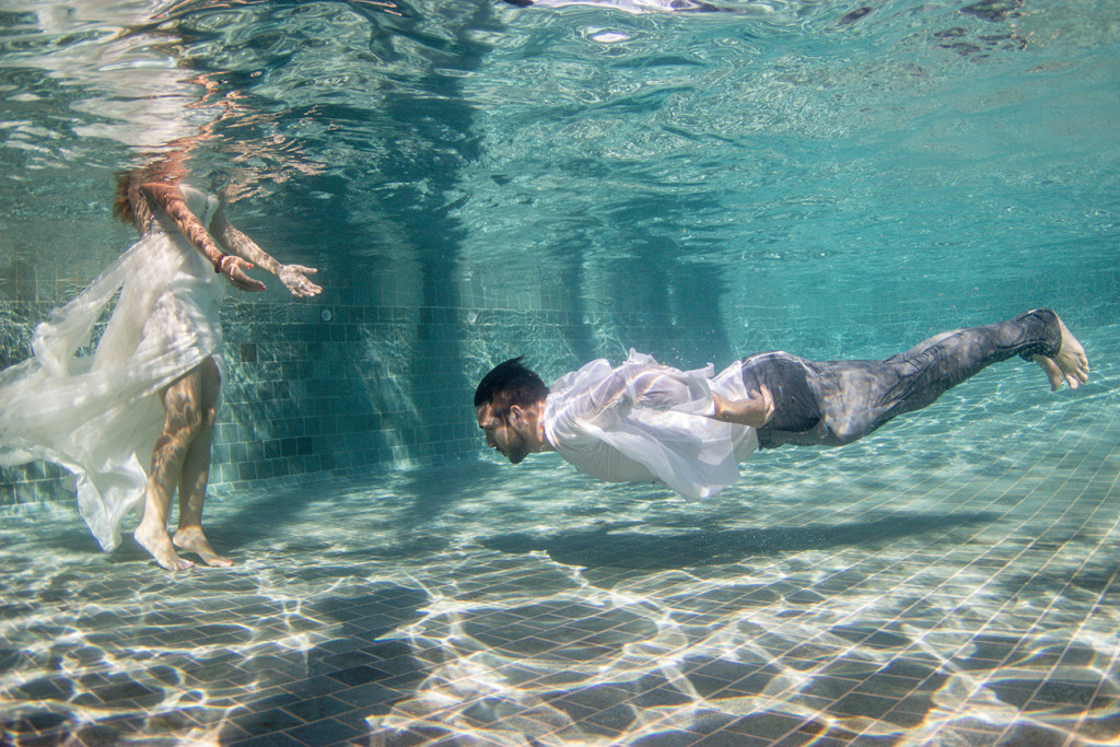 The Merman-like groom glides towards his bride underwater