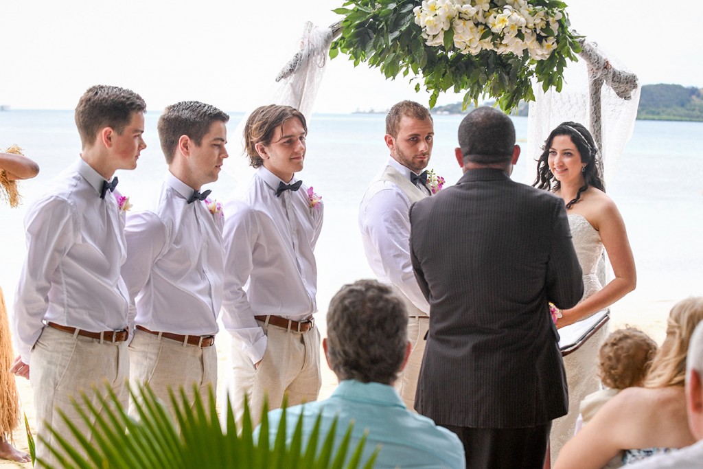 The groomsmen watch as the celebrant officiates the wedding ceremony