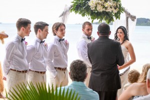 The groomsmen watch as the celebrant officiates the wedding ceremony