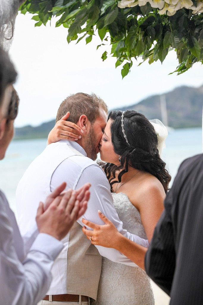 The newly-weds share a first passionate kiss as man and wife