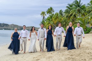The newly weds pose with the bridal party on the beach at Plantation Island Resort