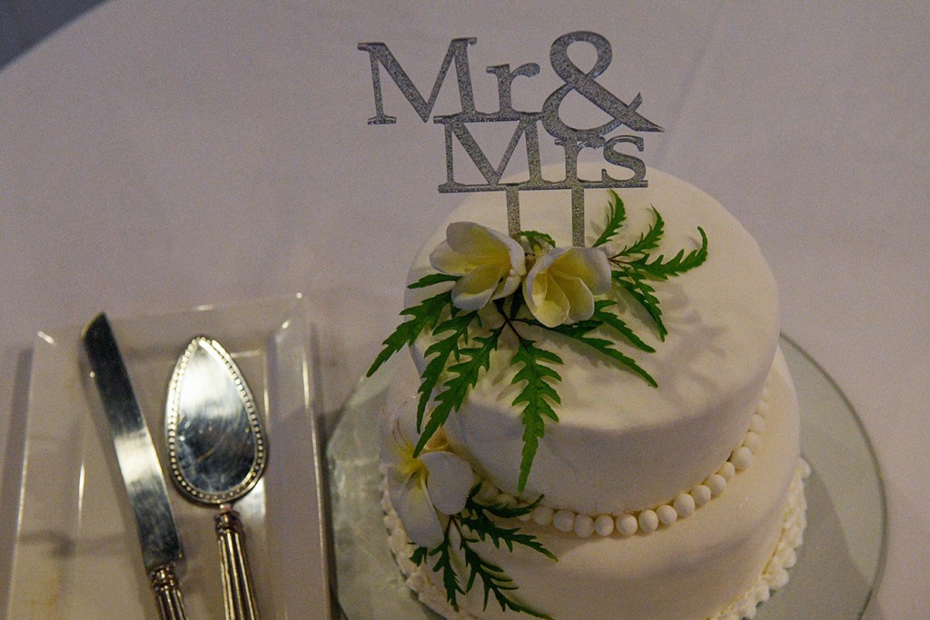 A simple, white two tier Wedding cake with Mr & Mrs topper