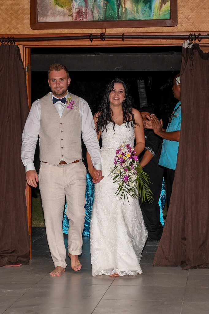 The newly weds arrive barefoot at their reception venue at Plantation Island Resort