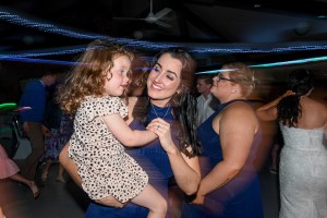 A mother dances with her daughter on the dance floor