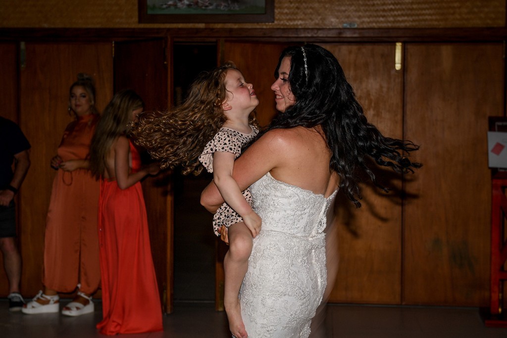 The bride has fun dancing with the flowergirl