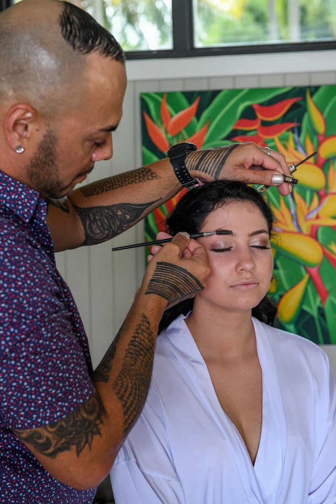 The makeup artist touches up a bridesmaid's eyebrow