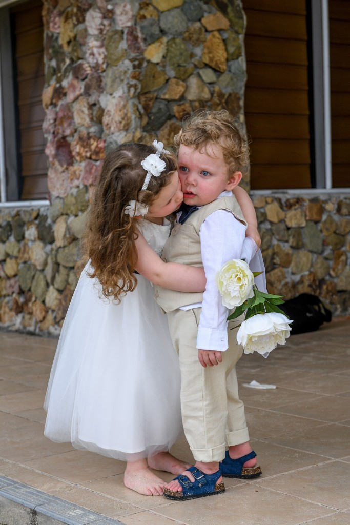 The flower girl hugs the page boy