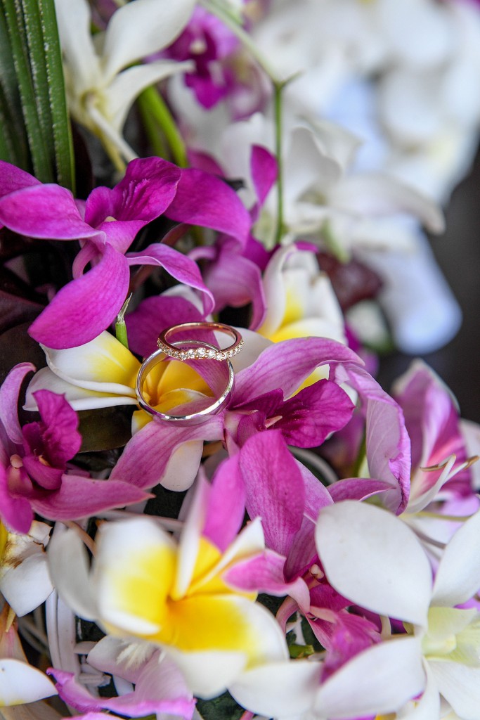 The rings are nested on fresh frangipani flowers