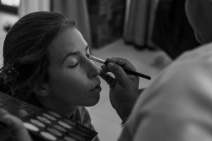 A monochrome picture of the bride having her makeup done