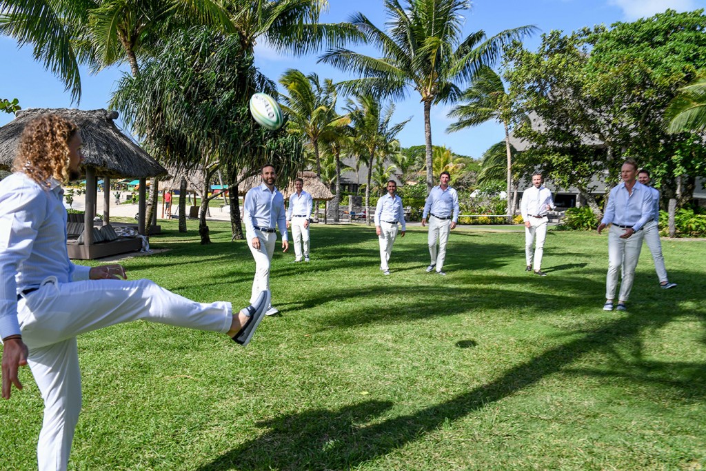 The groomsmen play a light game of rugby before the ceremony