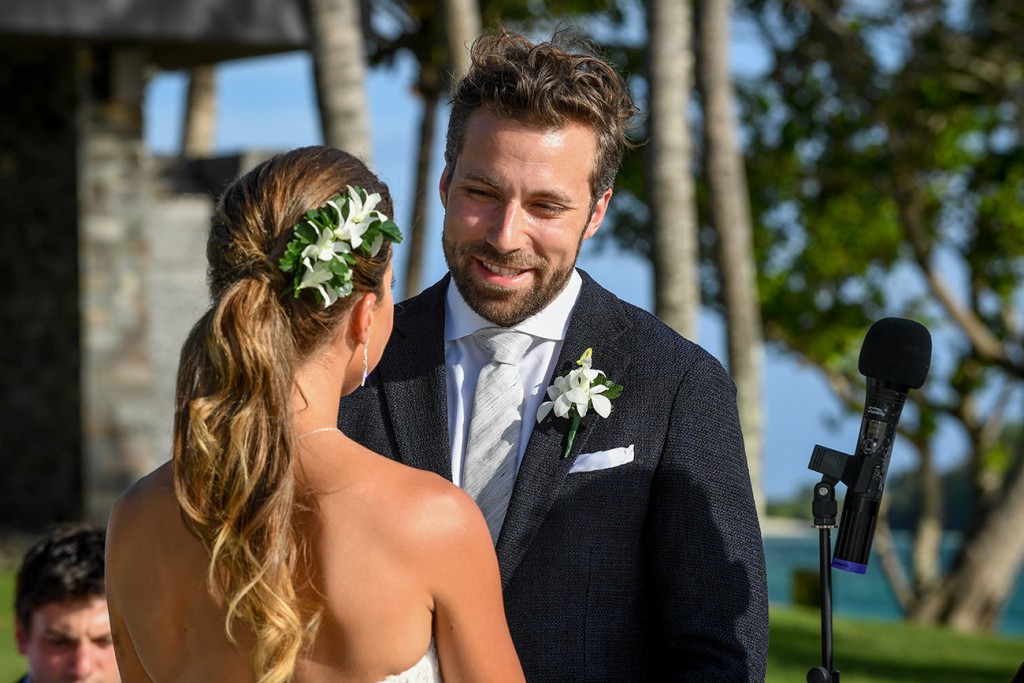 The groom looks lovingly at his bride as he says his vows