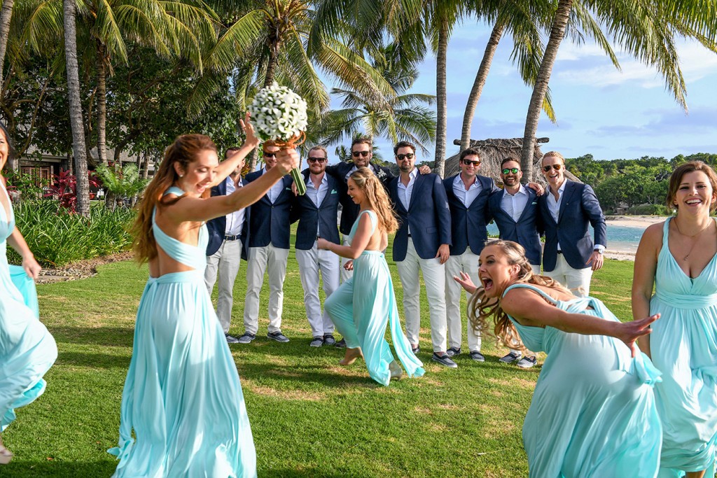 The bridesmaids photobomb the groomsmen's picture
