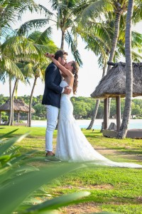 The newly-weds kiss under the palm trees at the Intercontinental Fiji