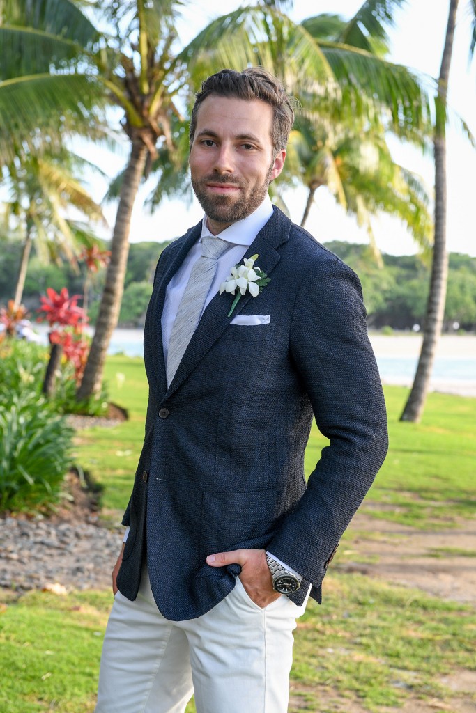 The dapper groom poses in his custom suit from Suit supply