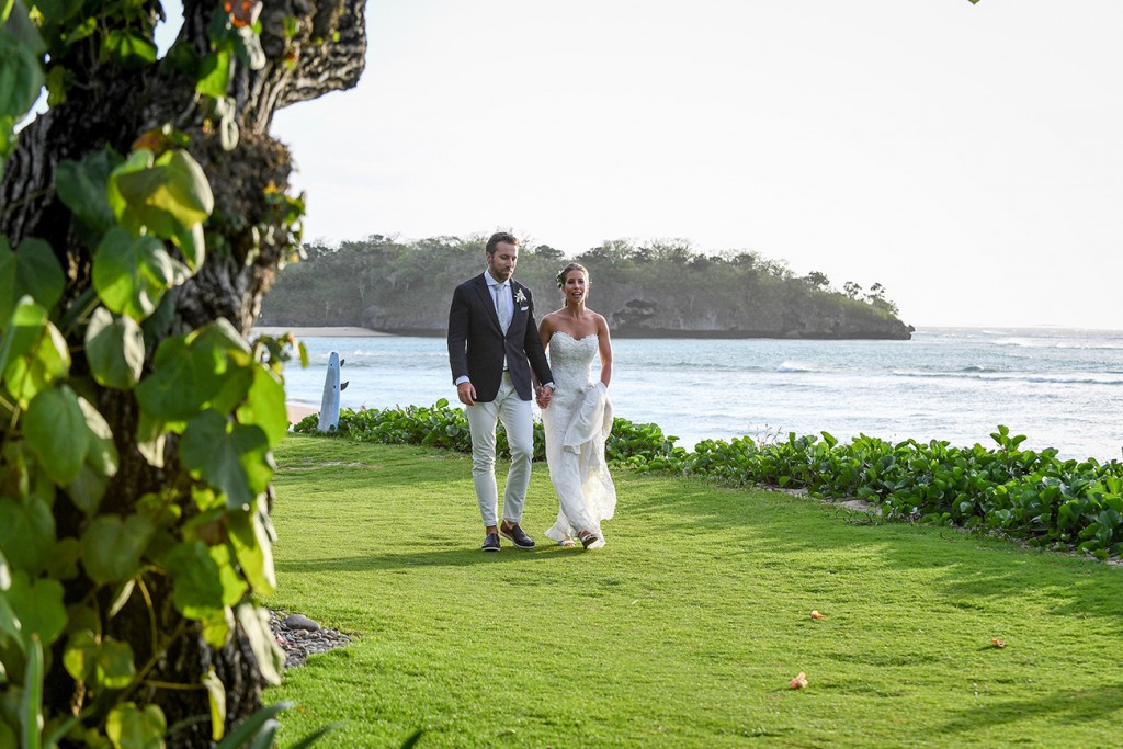 The newly weds stroll alongside the Pacific Ocean