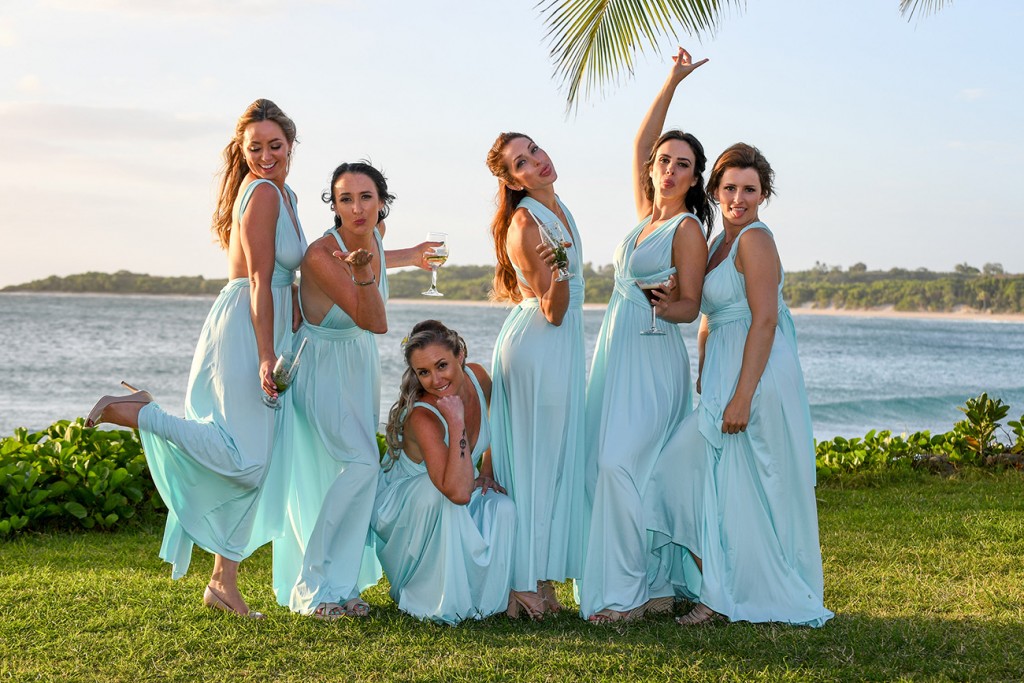 The bridesmaids pose for a cute pic by the beach