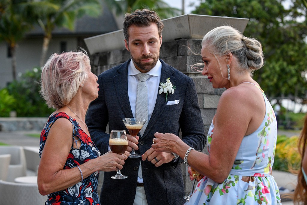 The groom chats with his two mothers
