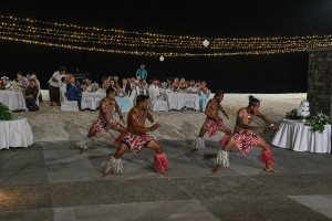 The traditional dancers dance under fairy lights as guests watch