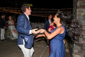 Wedding guests dance under fairy lights at the reception