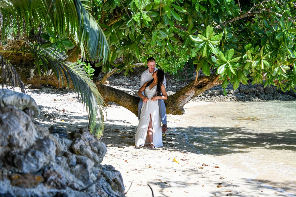 The newly-weds cuddle under a gigantic tree at Savasi