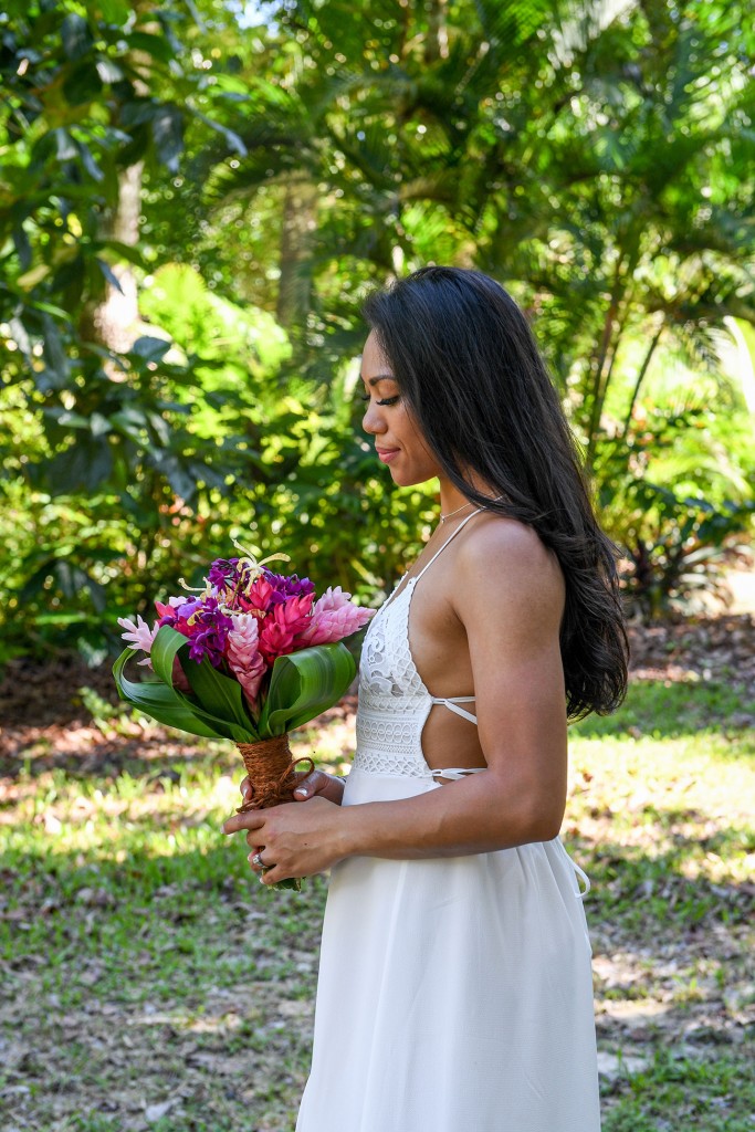 The stunning bride poses with her fresh, tropical Fiji flower bouquet