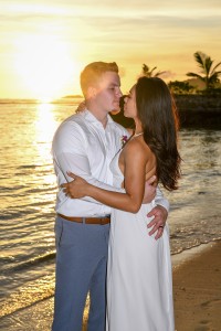 The couple kiss in the amber sunset at Savasi Fiji