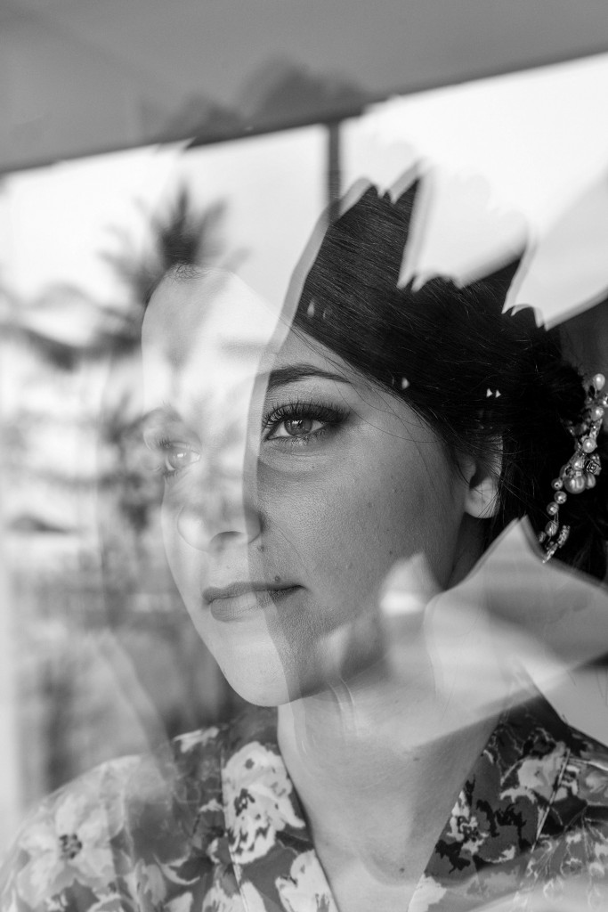 A stunning monochrome photo of the bride staring out of the window