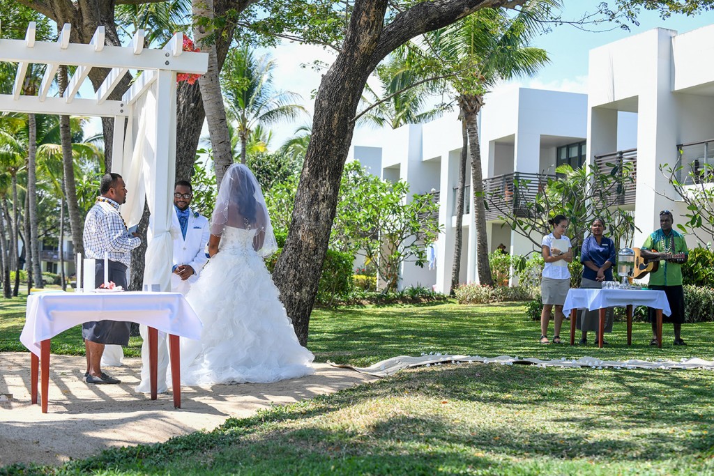 A wideshot of the married couple exchanging their vows at Hilton Fiji
