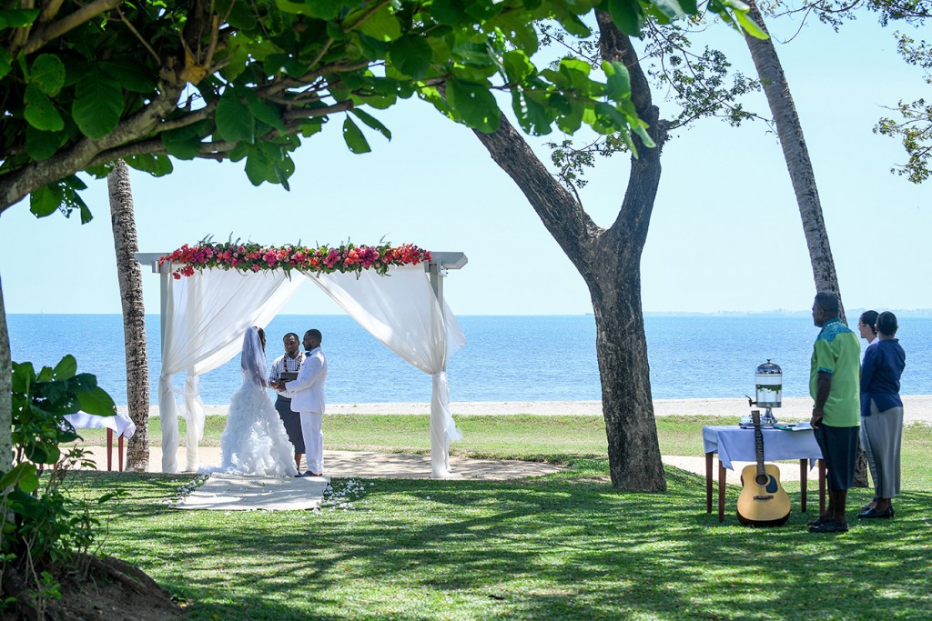 The couple exchanges their vows while overlooking the stunning sea at Fiji
