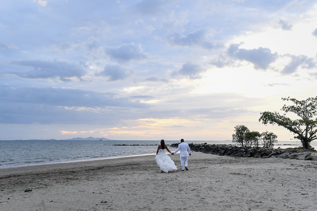 The bride and groom stroll into the stunning Fiji sunset