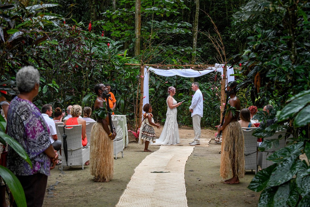 The bride and groom at the altar surrounded by Fiji Tropical Fores