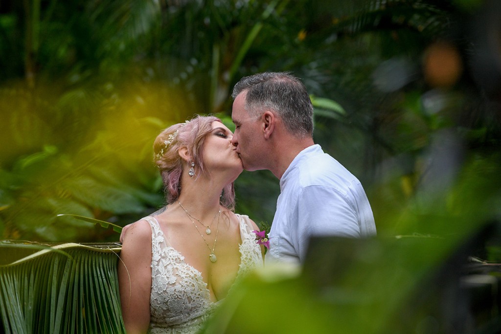 The newly weds share a passionate kiss in the heart of the forest